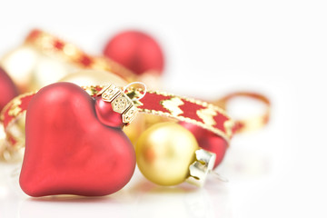 Red and gold christmas ornaments on white background
