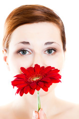 Beautiful young woman with gerber flower