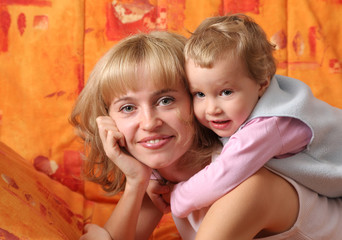 Cheerful mum plays with a daughter