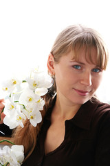 Beautiful young smiling woman with white orchids