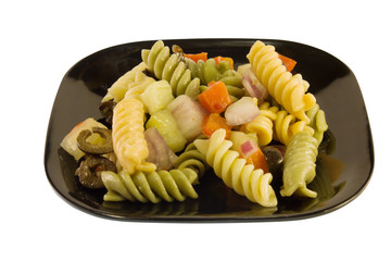 multi-colored pasta salad with onions, olives, and tomatoes