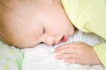 Restful two years baby boy sleeping on bed