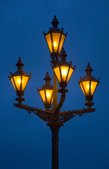 Fototapeta na wymiar Old-fashioned glowing lantern against the night sky