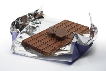 Brick of chocolate and sweetmets on white background