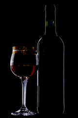 object on black - wine glass with bottle