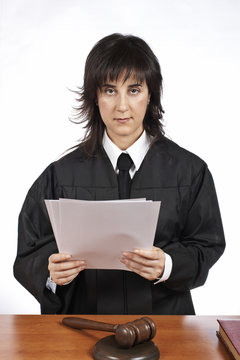 Female judge in a courtroom reading the verdict. Shallow DOF
