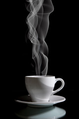 Cup of black coffee on the black background