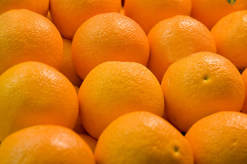 A display of fresh juicy naval oranges in a fruit market