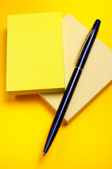 Yellow sticky note and pen