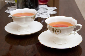 two porcelain cups with tea