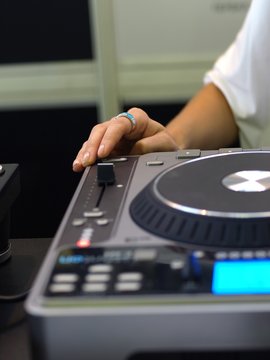 Close up of Lady's hand on DJ sound mixer