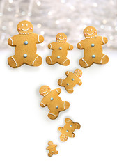 Gingerbread men cookies against sparkly white background