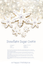 Snowflake sugar cookies with recipe on holiday background