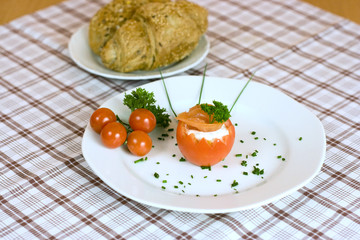 Red tomato with spread and bread
