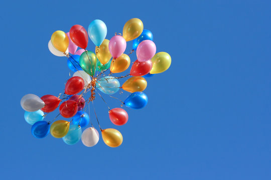 Coloured balloons isolated on blue.