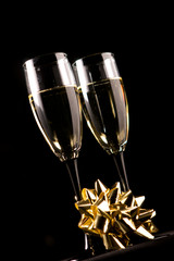 Champagne glasses with decoration isolated on black