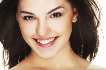 Fototapeta premium A happy young woman with big smile on white background