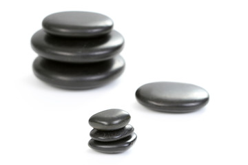 black pebbles isolated on white - health and beauty