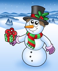 Christmas snowman in snowy landscape