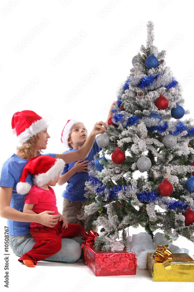 Poster happy mother and children over christmas tree