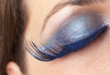 Macro shot of beautiful eyes with bright blue make-up