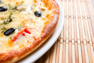 Supreme Pizza on plate.