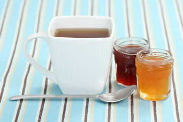 cup of delicious tea with sweet confiture