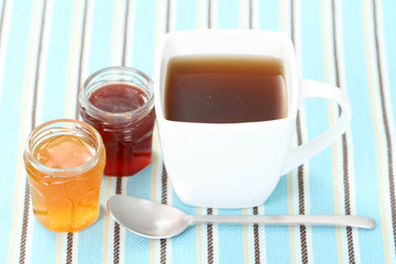 cup of delicious tea with sweet confiture