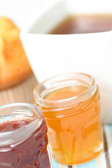 cup of delicious tea with sweet muffin and confiture