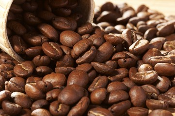 Cup with coffee, costing on coffee grain