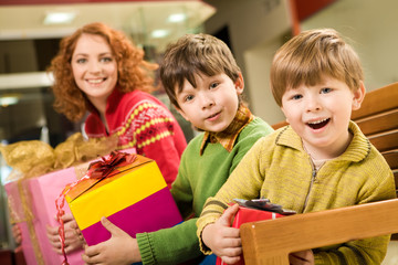 Portrait of astonished brothers with nice gifts