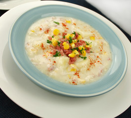 Freshly prepared ham corn and potato chowder with paprika