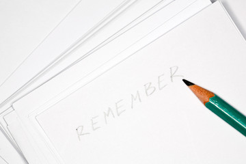 Closeup image of green pencil on notepad