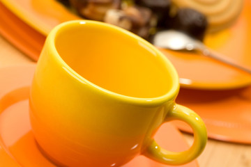Close-up of orange coffee cup.