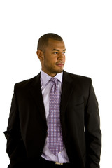 A black man in a nice suit with his hands in his pockets