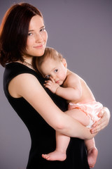 Smiling Mother Hugs Baby Girl