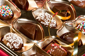 Assorted chocolate candy in a box with Christmas decoration