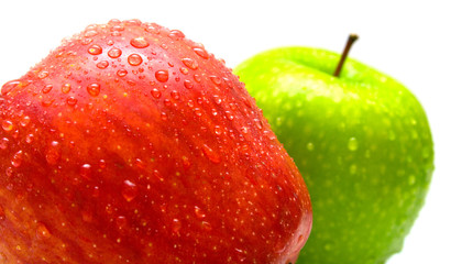 apples covered by water drops on the white. Isolated.