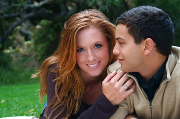 Fototapeta premium Young couple in an autumn forest picnic area