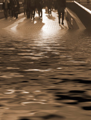 Business people walking on a bridge covered in flood water