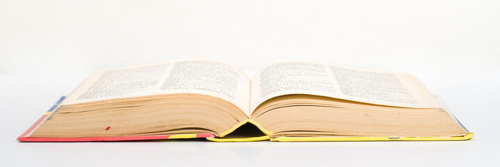 Open old book on white background