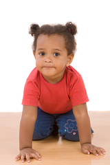 Naklejka premium Adorable african baby crawl over wooden floor