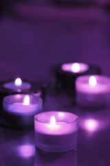 five burning candles on the table (purple)