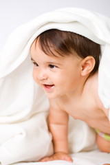 Fototapeta na wymiar Smiling happy 8 months old baby girl, white background.