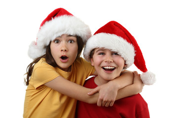 Kids wearing Santa Claus hats isolated on white background