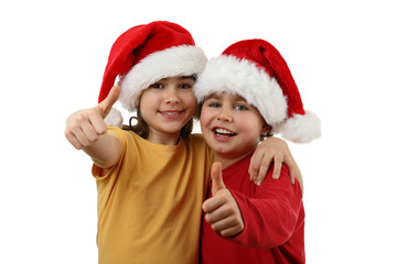 Kids wearing Santa Claus hats showing OK sign , isolated