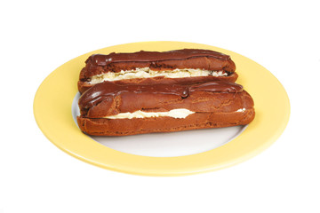 Two chocolate eclairs on a plate