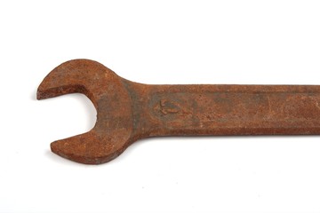 Old rusty spanner isolated on white background.