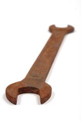 Old rusty spanner isolated on white background.