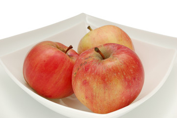 three red apples on plate